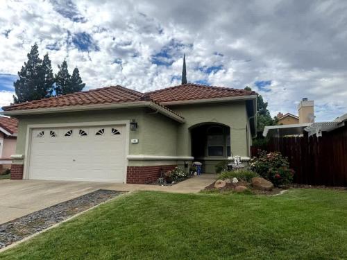 a house with a white garage in a yard at Modern Folsom Family Home Near Trails & Shopping in Folsom