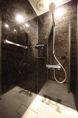 a bathroom with a shower with a glass door at FUJI TIME TRAVELER Morino in Fujikawaguchiko