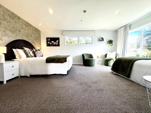 a bedroom with two beds and a window at 64 Mandalea B&B in Ohoka