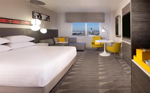 a hotel room with a bed and a living room at Hyatt Regency Los Angeles International Airport in Los Angeles