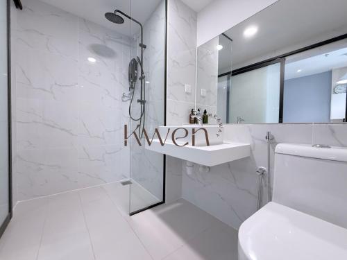 a white bathroom with a shower and a sink at KWEN Vetro11 - Charm of KK City in Kota Kinabalu