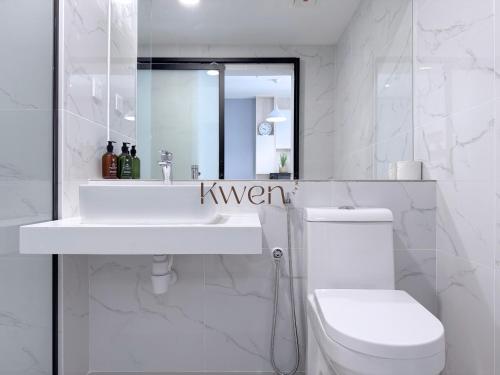 a white bathroom with a sink and a toilet at KWEN Vetro11 - Charm of KK City in Kota Kinabalu