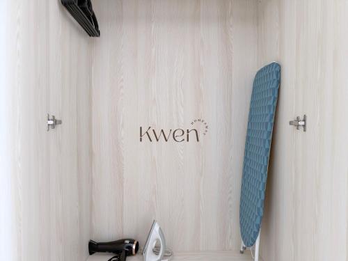 a mirror on a wall next to a sink at KWEN Vetro11 - Charm of KK City in Kota Kinabalu