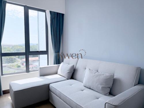 a white couch in a room with a large window at KWEN Vetro11 - Charm of KK City in Kota Kinabalu