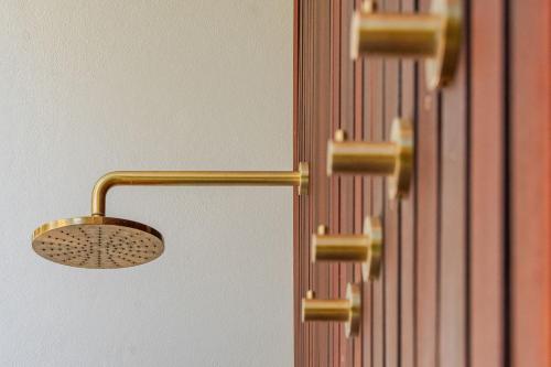 a close up of a shower head on a wall at Lady Luxe - Beautiful spacious pet friendly home near the ocean in Byron Bay