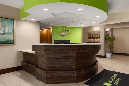 a lobby of a hospital with a reception counter at Wyndham Garden Washington DC North in Washington