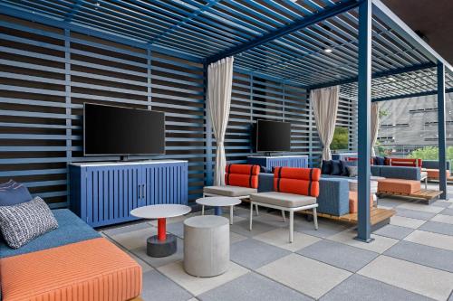 a living room with furniture and a flat screen tv at Cambria Hotel Austin Downtown in Austin