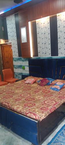 a large bed in a room with a table at Kanha ji Divine dham 89799Vrindavan12972, free pick up also taxi and Activa rent in Mathura