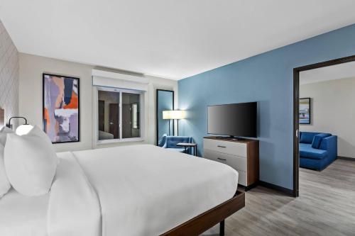 a hotel room with a bed and a television at Everhome Suites Ocala I-75 North in Ocala