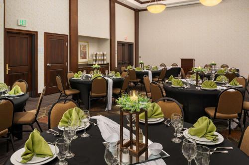 a conference room with tables and chairs with green napkins at Staybridge Suites Everett - Paine Field by IHG in Mukilteo