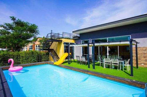 a house with a swimming pool with a slide at The X10 Nordic Tent and Glamping Pool Villa Khaoyai เขาใหญ่ - SHA Certified in Ban Thung Sawang