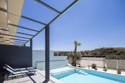 a swimming pool with a view of a house at Villa Me - With Private Pool in Roumelí