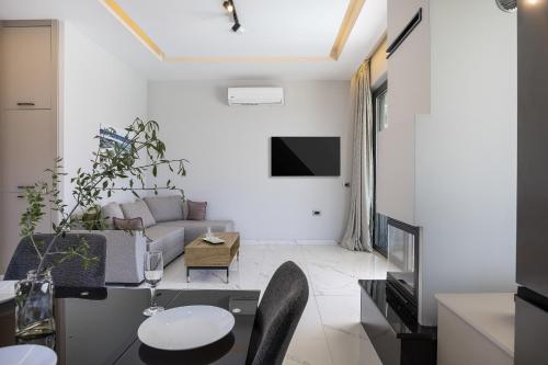 a living room with a couch and a table at Villa Me - With Private Pool in Roumelí