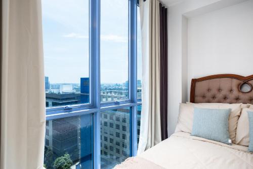 a bedroom with a bed and a large window at Virgo Nest Rentals - 38th Park Ave, IT Park Cebu City View in Cebu City
