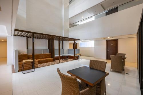 a dining room with a table and chairs at Virgo Nest Rentals - 38th Park Ave, IT Park Cebu City View in Cebu City
