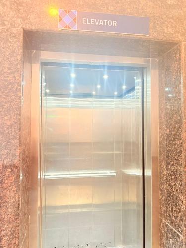 a elevator in a building with a sign above it at Hotel Melano in Zirakpur