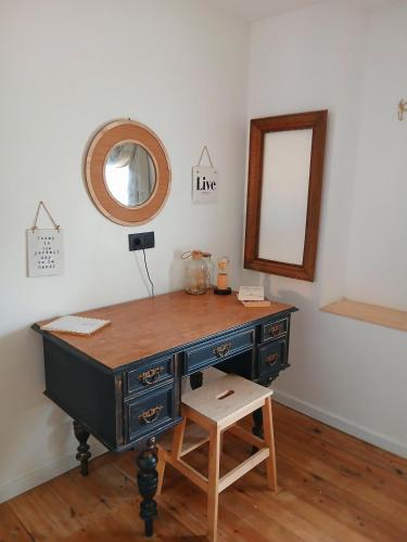 a dressing table with a mirror and a stool at L’idée du jour in Onhaye
