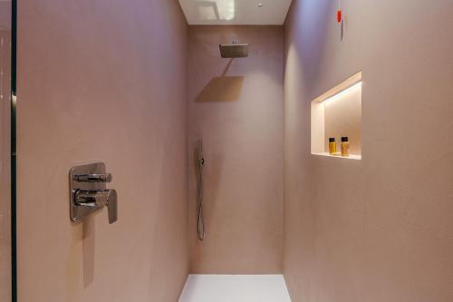 a bathroom with a shower with a toilet and a mirror at Deville & Spa in Costermano sul Garda