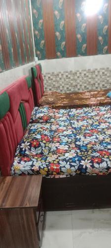 a couple of beds sitting in a room at Kanha ji Divine dham 89799Vrindavan12972, free pick up also taxi and Activa rent in Mathura