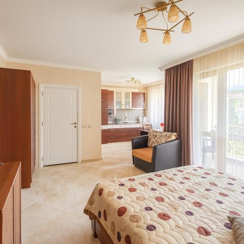 a bedroom with a bed and a living room at Romantic Studio Florence in Sveti Vlas