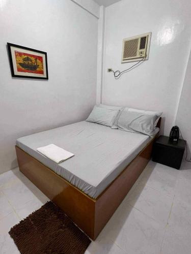 a bedroom with a bed with a air conditioner at A & L Resort - Sea & Mountain View in Looc