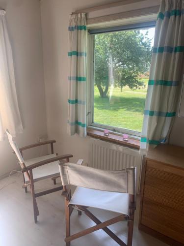 a room with two chairs and a window at Casita amarilla in Helsinge