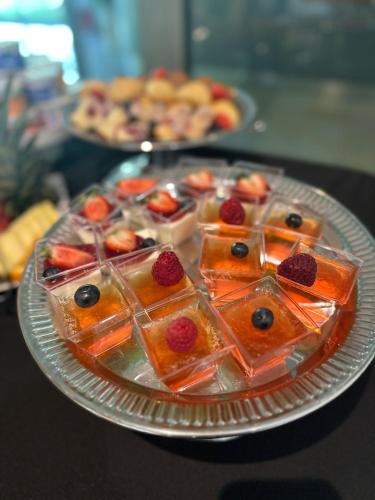 a plate of food with fruit on a table at Hotel Sobieszewo in Gdańsk