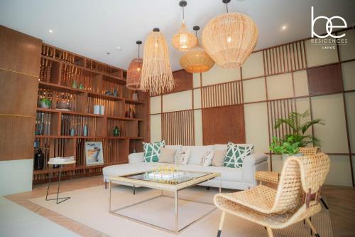 a living room with a couch and a table at Cozy 1 bedroom at BE Residences Condominium with balcony near IT Park in Tabok