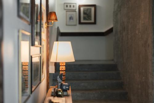 a lamp sitting on a table next to a staircase at Sugar Marina Hotel -AVIATOR- Phuket Airport in Nai Yang Beach