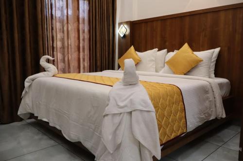 a hotel room with two beds with towels on them at Rhythm Stays in Munnar