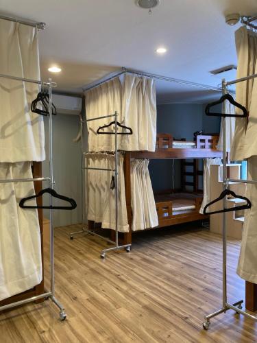 a room with a stage with curtains and shelves at J-Hoppers Beppu Guesthouse ジェイホッパーズ別府ゲストハウス in Beppu