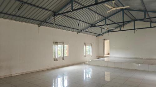 a large room with white walls and a ceiling at Golden Hill Resort in Chikmagalūr