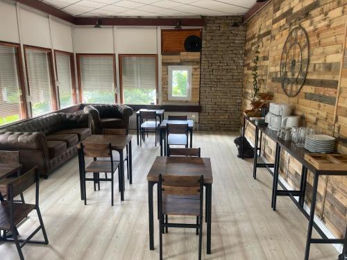 a living room with tables and chairs and a couch at Chambre l'Ecureuil in Cernon