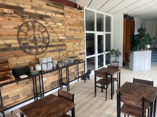 a restaurant with wooden walls and tables and chairs at Chambre l'Ecureuil in Cernon
