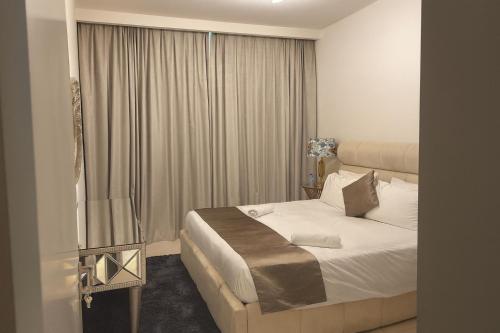 a hotel room with a bed and a window at Best Emaar Beachfront view one bedroom in Dubai