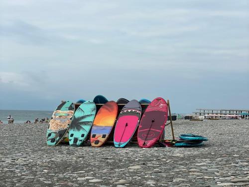 a group of surfboards lined up on a beach at Skyline Apartments Batumi in Batumi