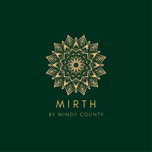 a gold mandala logo on a green background at Mirth by Windy County in Vagamon