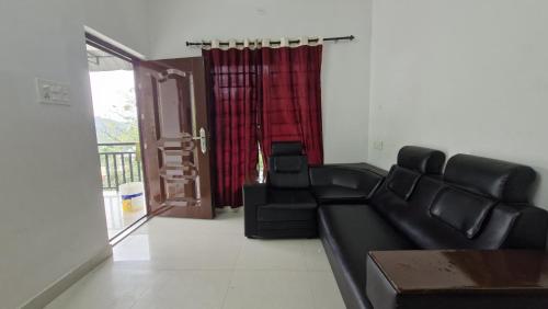 a living room with a couch and a chair at Mirth by Windy County in Vagamon