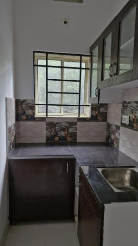 a large kitchen with a sink and a window at Mirth by Windy County in Vagamon