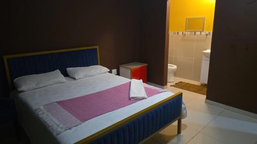 a bedroom with a bed and a bathroom with a toilet at EzekMary Res in Polokwane