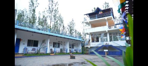 a building with a basketball court in front of it at Silver Vibes Homestay in Chikmagalūr