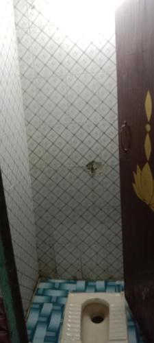 a bathroom with a toilet in a bathroom stall at Kanha ji Divine dham 89799Vrindavan12972, free pick up also taxi and Activa rent in Mathura