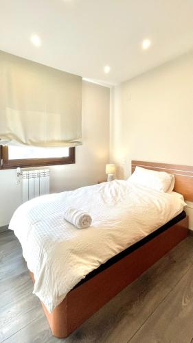 a bedroom with a large bed with two towels on it at Casa Licinia in Aguilar de Campóo
