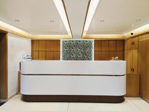 a lobby of a hospital with a reception counter at Hotel Comfort in Surat