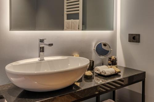 a bathroom with a large white sink on a counter at Deville & Spa in Costermano sul Garda