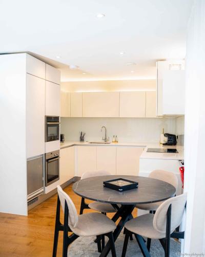 a kitchen with a table and chairs in a room at A home away from home! in London