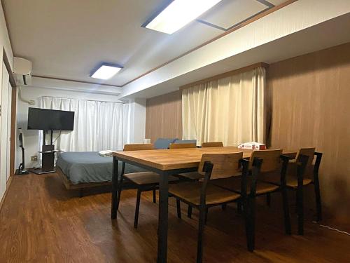 a room with a table and chairs and a bed at Ema eve HOUSE in Tokyo