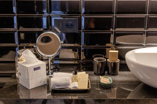 a bathroom counter with a sink and a mirror at Deville & Spa in Costermano sul Garda