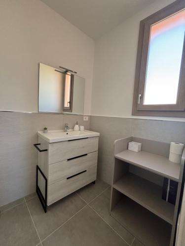 a bathroom with a sink and a mirror at La Pulvarera in Castelsardo
