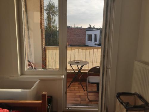 a view of a balcony with a table and a window at Luxurious 2 bedroom appartment in Antwerp